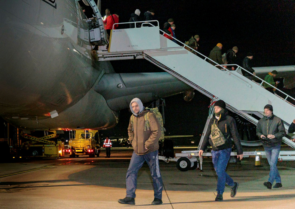 Image shows civilians departing RAF Voyager aircraft.